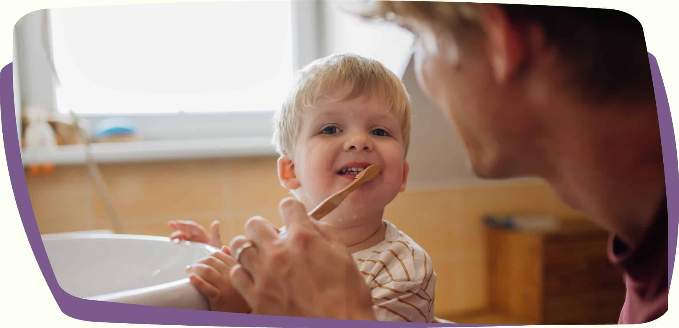 father brushing childs teeth in lafayette la