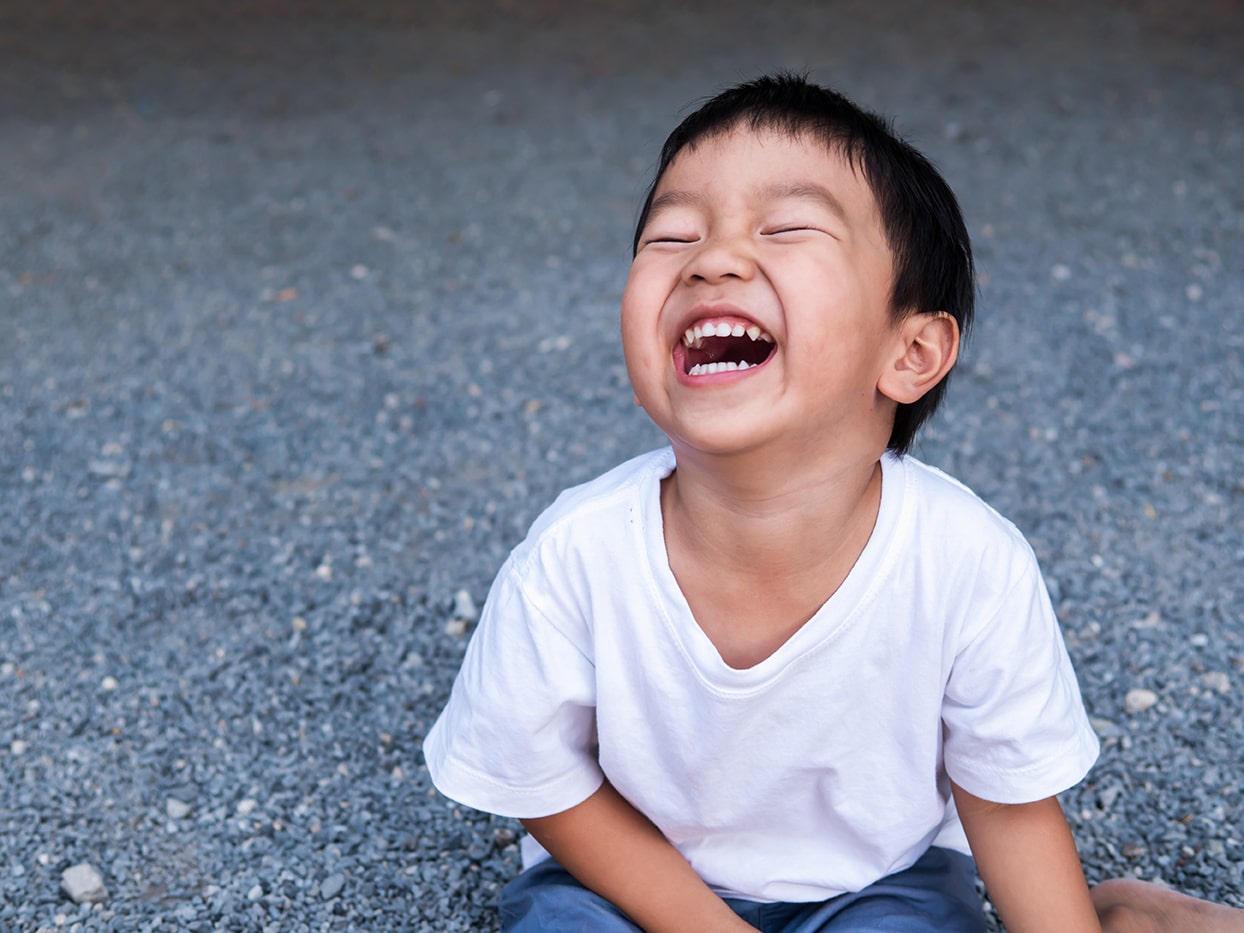 child smiling with his baby teeth in lafayette la